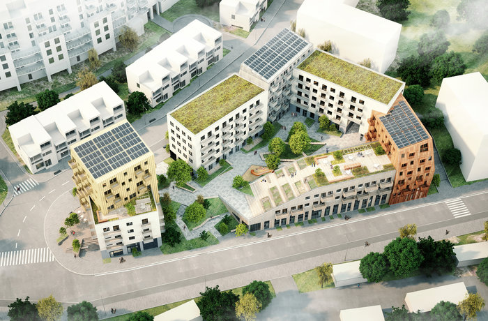 Översiktsbild över ett triangulärt bostadskvarter med 7 hus i skala mellan 3-7 våningar, runt en innergård. Gröna tak och solpaneler. 